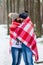 Beautiful Young Couple Walking in Snowy Winter Forest Embrace