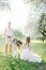 Beautiful young couple in wedding dress with greyhounds in park