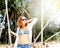 Beautiful young curly funny girl on a swing on a tropical beach, freedom, vacation, travel, joy and happiness concept