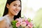 A beautiful young cute black long hair Asian woman holding a sweet color roses bouquet  with happy and deep love emotion