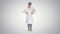 Beautiful young doctor changing poses on gradient background.