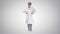 Beautiful young doctor changing poses on gradient background.