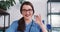 Beautiful young doctor woman in blue nurse uniform smiling at camera showing vaccine flask. Hope in fighting coronavirus