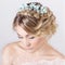 Beautiful young elegant sweet girl in the image of a bride with hair and flowers in her hair , delicate wedding makeup