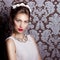 Beautiful young elegant woman with red lips, beautiful stylish hairstyle with white flowers in her hair, the way