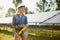 Beautiful young engineer near solar panels outdoors