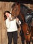 Beautiful young equestrian woman in winter country