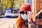 Beautiful young European woman with ginger coloured hair on the street with a medical face mask on