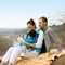 Beautiful young family lying on a blanket and looking at tablet