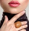 Beautiful young fashion woman with living coral lipstick. Attractive white girl wears luxury jewelry