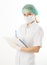 Beautiful young female doctor in medical gown and