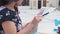 Beautiful young female examining city map, writing in notebook, making notes