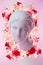 Beautiful young female face and colorful flowers. Plaster antique bust of Venus in a floral wreath. Beauty spring and
