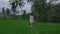 Beautiful young female model in tunic walking along the rice field on Bali with wonderful view