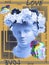 Beautiful young female pink face and colorful flowers on textured background . Plaster antique bust of Venus in a floral
