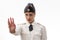 Beautiful young female Russian police officer in dress uniform shows a stop sign with her hands on a white background.
