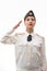 A beautiful young female Russian police officer in dress uniform and a white shirt on a white background salutes the commander.