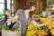 Beautiful young female shopping for fruits in market