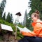 Beautiful young female tourist looking at map