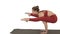Beautiful young fit woman wearing sportswear doing handstand, variation of Firefly posture, Tittibhasana on white