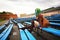 Beautiful young girl with bag posing on bench on football stadium