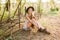 Beautiful young girl with blond hair in a suede jacket with fringed and black felt hat in the countryside on a sunny autumn day