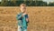 Beautiful young girl blowing soap bubbles during rotation in autumn field