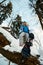 Beautiful young girl in a blue ski suit and helmet. On the head are glasses for snowboarding. Snow-covered mountain