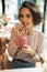 Beautiful young girl drinking smoothie cocktail