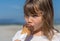 Beautiful young girl enjoying an ice cream cone in summer