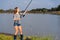 Beautiful young girl fishes on the lake