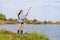 Beautiful young girl fishes on the lake