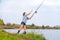 Beautiful young girl fishes on the lake