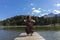 Beautiful young girl and former woman plays her cello on a wooden jetty