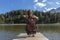 Beautiful young girl and former woman plays her cello on a wooden jetty