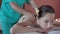 Beautiful young girl having massage in spa salon