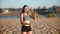 Beautiful young girl hiding from the sun with her hands while playing volleyball