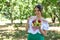 Beautiful young girl holding a plate of fruit and thumb raised up