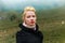 Beautiful young girl on a horse in the mountains in the mist