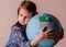 Beautiful young girl hugs globe of world. Ecology, health, problem of war and peace concept