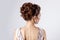 Beautiful young girl in the image of the bride, beautiful wedding hairstyle with flowers in her hair, hairstyle for bride