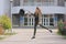 Beautiful young girl jumping on a university background