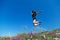 Beautiful, young girl jumps on the slope of a ridge.  Late spring early summer Gelendzhik