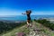 Beautiful, young girl jumps on the slope of a ridge.  Late spring early summer Gelendzhik