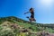 Beautiful, young girl jumps on the slope of a ridge.  Late spring early summer Gelendzhik