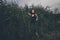 Beautiful young girl in the jungle in grass thickets in dress