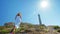 A beautiful young girl, looks at an lighthouse, in a straw hat. Concept: recreation, beautiful view, freedom, travel and