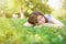 Beautiful young girl lying on a fallen in park. Smiling student woman sleep on book in fall forest. Seasons, dream, lifestyle, edu