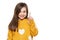 Beautiful young girl in mustard yellow sweater looking at camera, smiling and pointing up. Waist up studio shot white background.