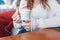 Beautiful young girl in outdoor cafe drinks coffee